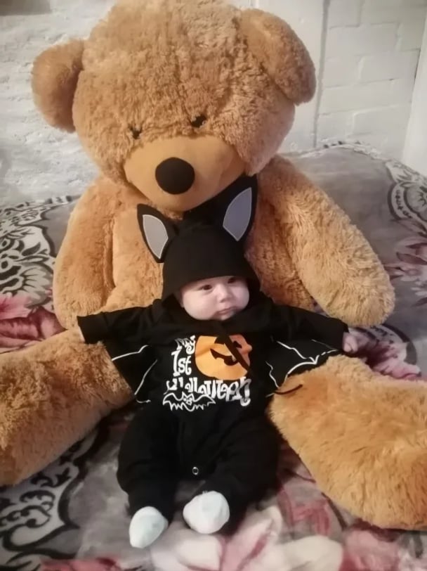 Baby wearing Halloween bat outfit