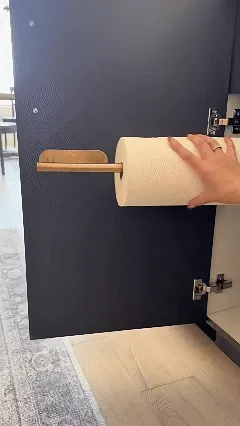 Under cabinet paper towel holder in use