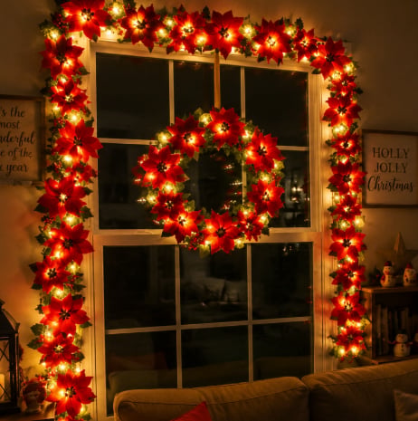 LED poinsettia garland arranged around a Christmas window